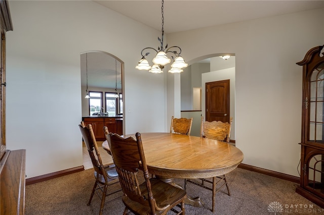 dining area featuring a chandelier and carpet floors