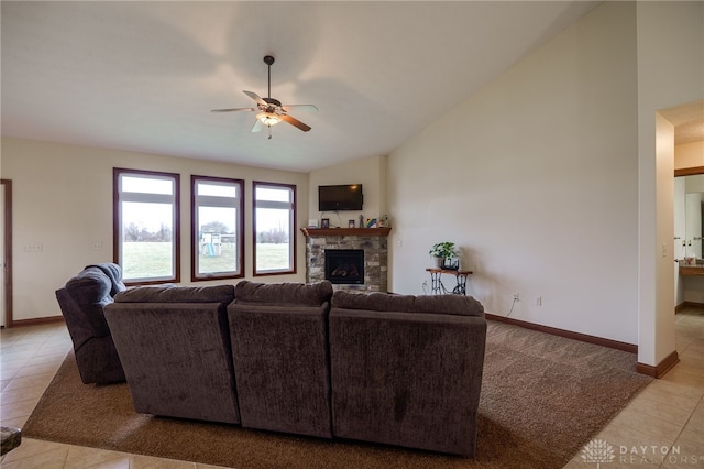 living room with ceiling fan, lofted ceiling, and a fireplace