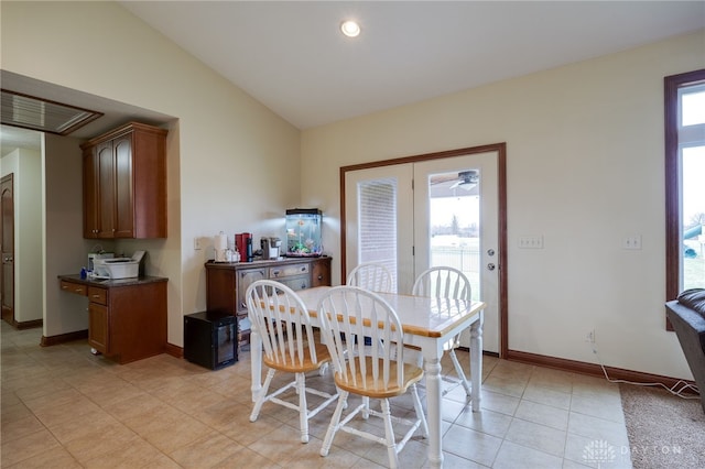 tiled dining space with vaulted ceiling