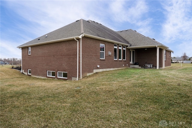 rear view of house with a yard