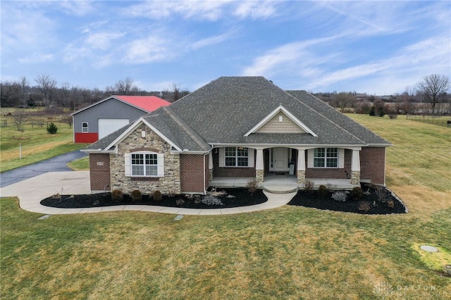 craftsman inspired home with a front yard and covered porch