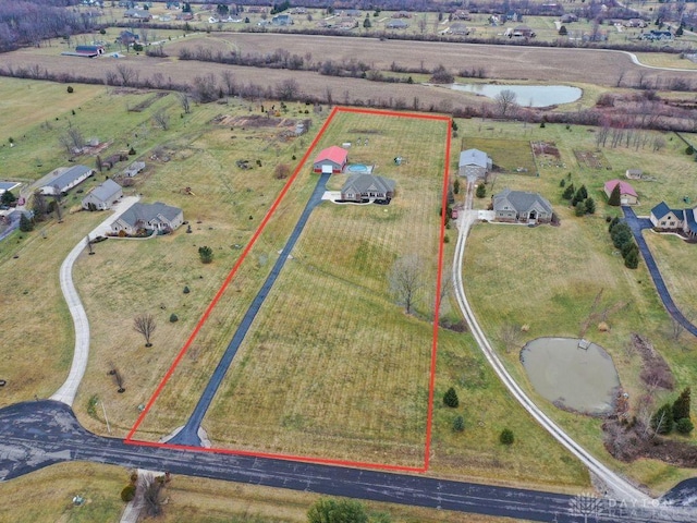 birds eye view of property with a rural view