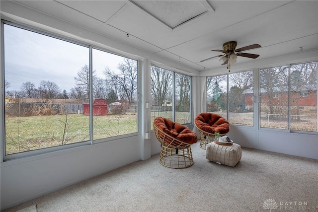 sunroom / solarium featuring ceiling fan