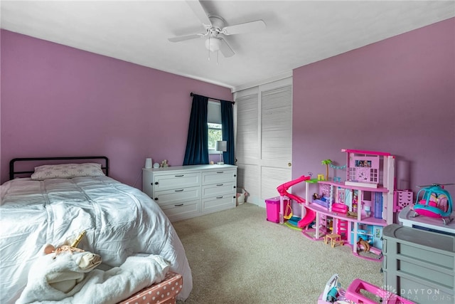 carpeted bedroom featuring ceiling fan and a closet