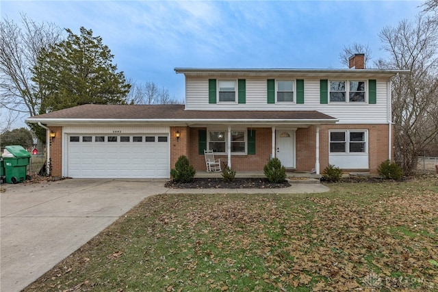 front of property with a porch, a garage, and a front yard