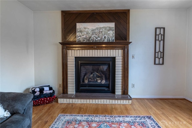 interior details with hardwood / wood-style flooring and a fireplace