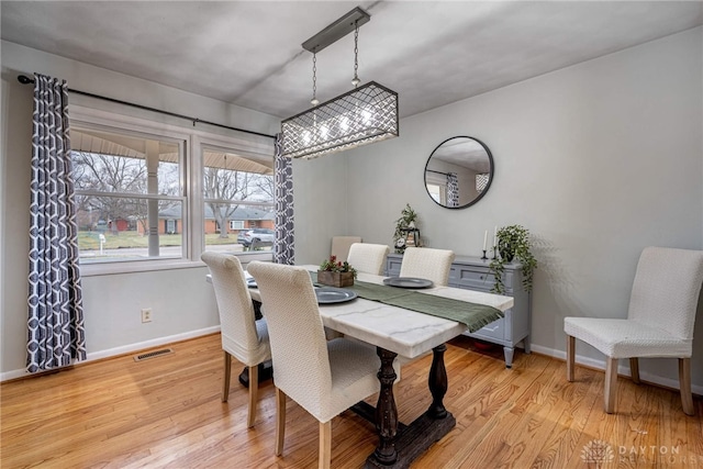 dining space featuring light wood-type flooring