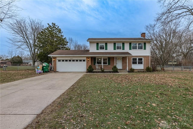 view of front property featuring a garage, a front yard, and a porch