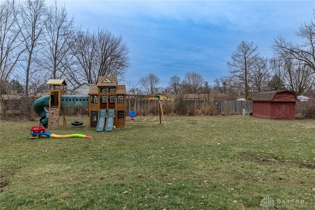 view of yard with a playground and a storage shed