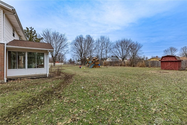 view of yard featuring a storage shed and a playground