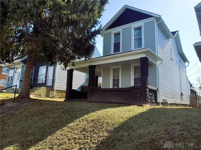 view of front of property featuring a front lawn and covered porch