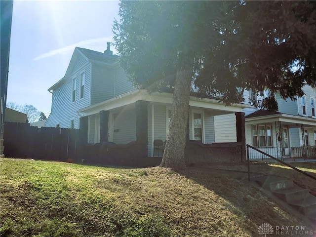 view of side of property with a yard