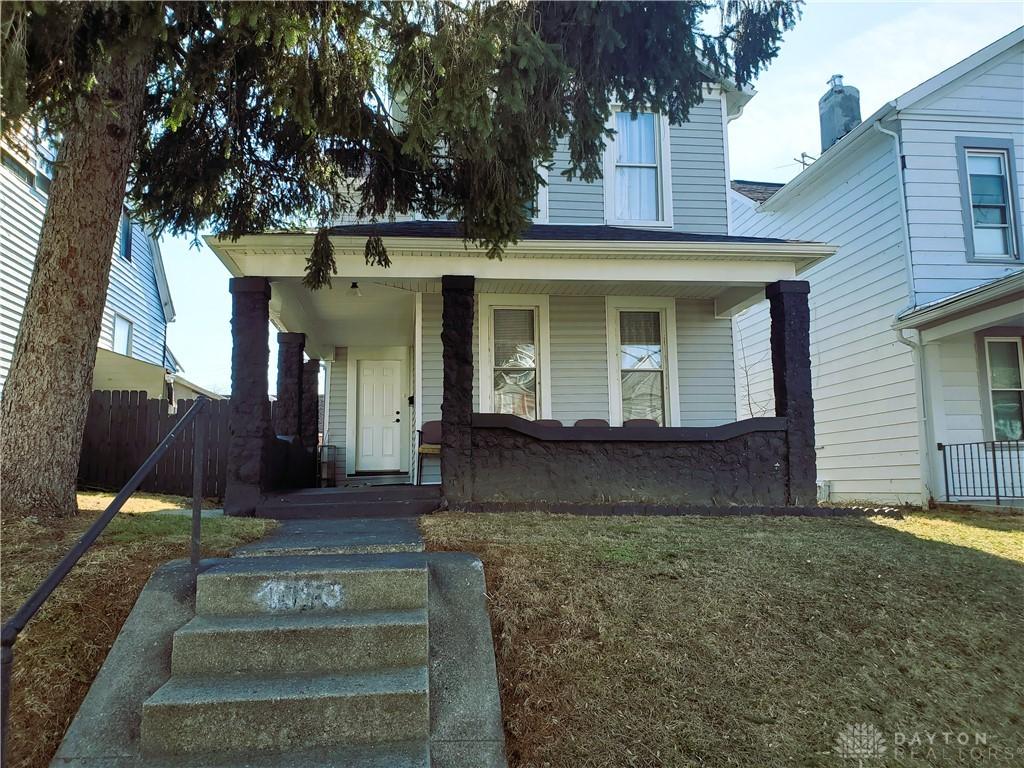 bungalow featuring a porch and a front lawn