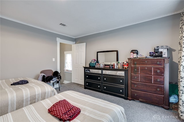 carpeted bedroom with visible vents and ornamental molding