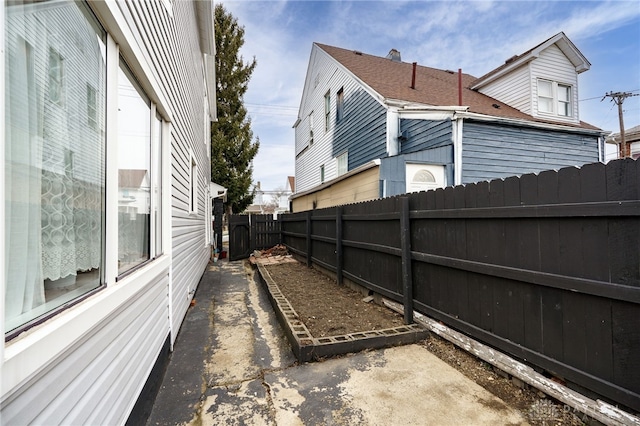 view of side of home with a fenced backyard