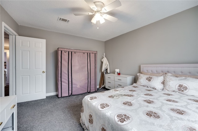 carpeted bedroom with baseboards, visible vents, a textured ceiling, and a ceiling fan