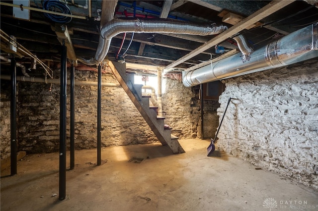 unfinished basement featuring stairway