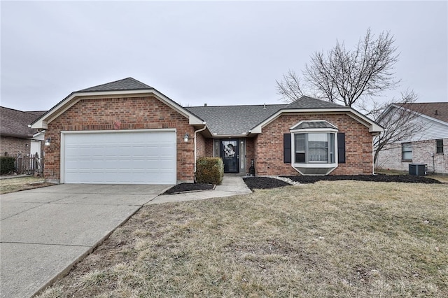 single story home with a garage, cooling unit, and a front yard