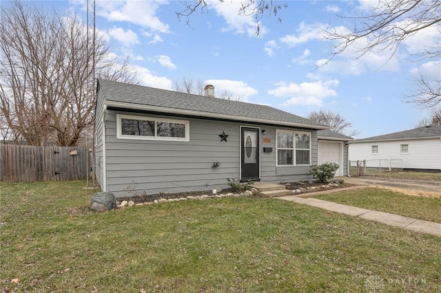 bungalow featuring a garage and a front lawn