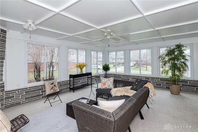 sunroom with ceiling fan, a healthy amount of sunlight, and coffered ceiling