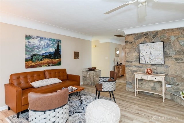 living room with ceiling fan and light wood-type flooring