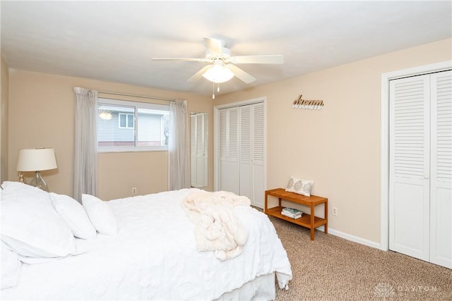 bedroom featuring ceiling fan, carpet floors, and multiple closets