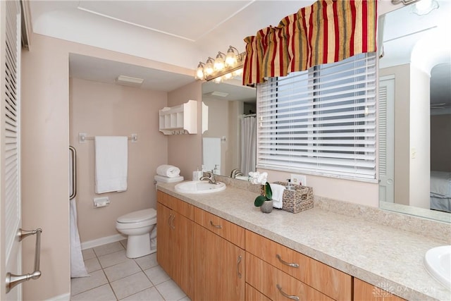 bathroom with vanity, tile patterned floors, and toilet