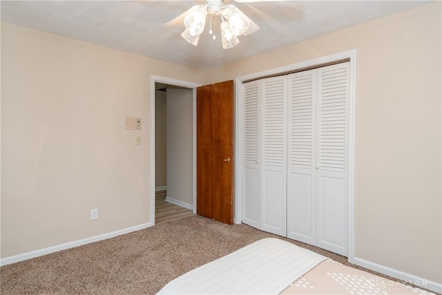 unfurnished bedroom with light carpet, ceiling fan, and a closet