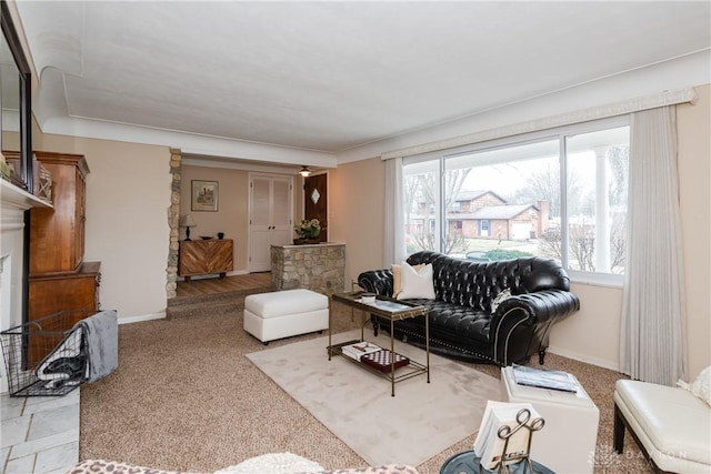 living room featuring a stone fireplace