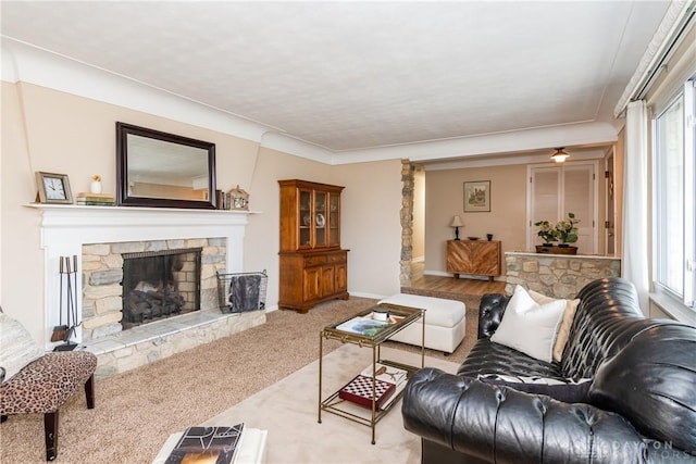 carpeted living room with a wealth of natural light and a fireplace