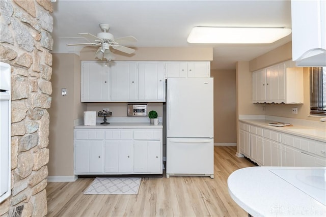 kitchen featuring sink, white cabinetry, white fridge, ceiling fan, and light hardwood / wood-style floors