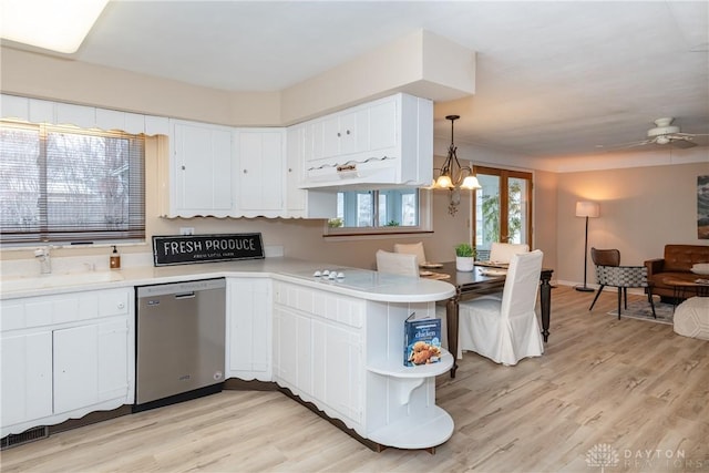 kitchen featuring sink, white cabinetry, hanging light fixtures, kitchen peninsula, and dishwasher