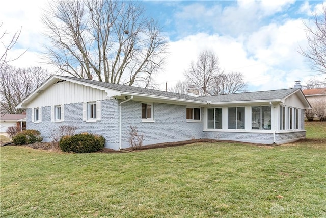 view of side of home with a lawn and a sunroom