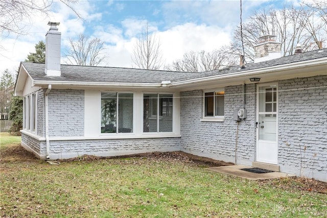 entrance to property with a lawn