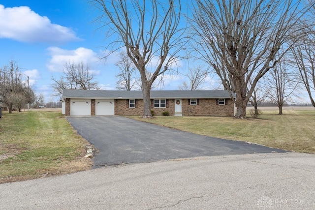 ranch-style home with a garage and a front lawn