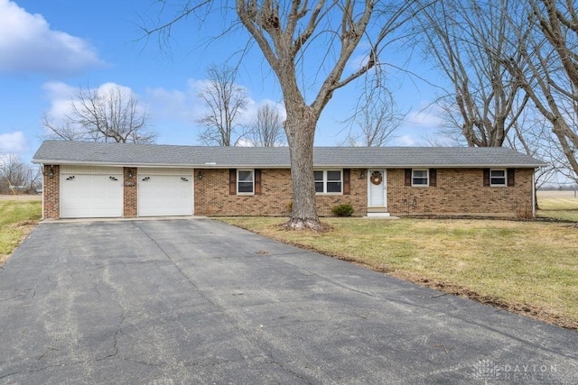 ranch-style house with a garage and a front yard