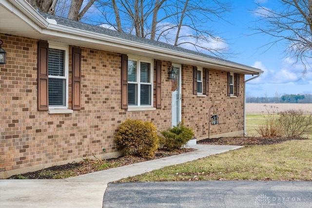 view of exterior entry with a lawn