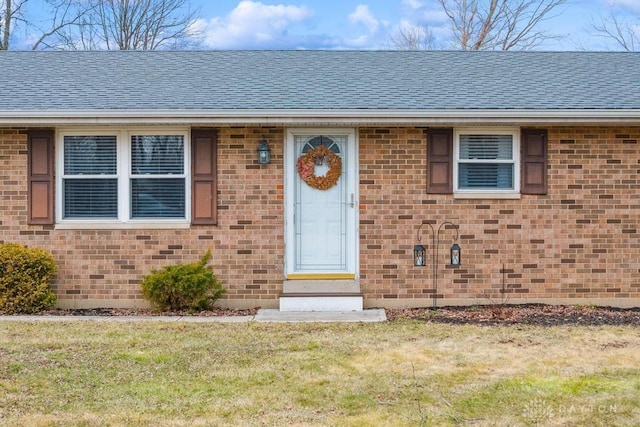 doorway to property featuring a yard