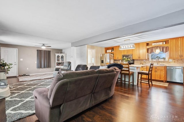 living room featuring dark wood-type flooring and sink