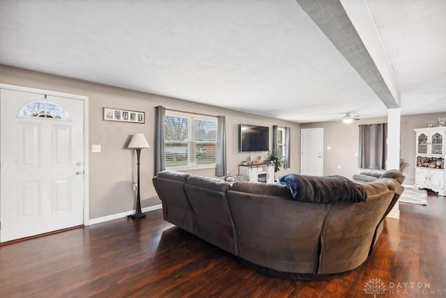 living room with dark wood-type flooring and ceiling fan