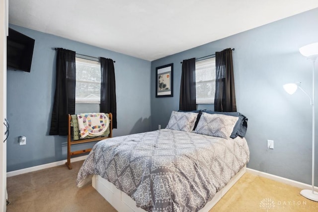 carpeted bedroom with multiple windows