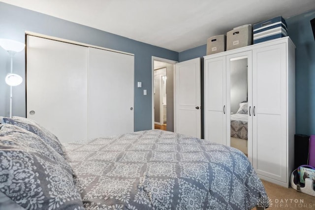 bedroom with carpet flooring and a closet