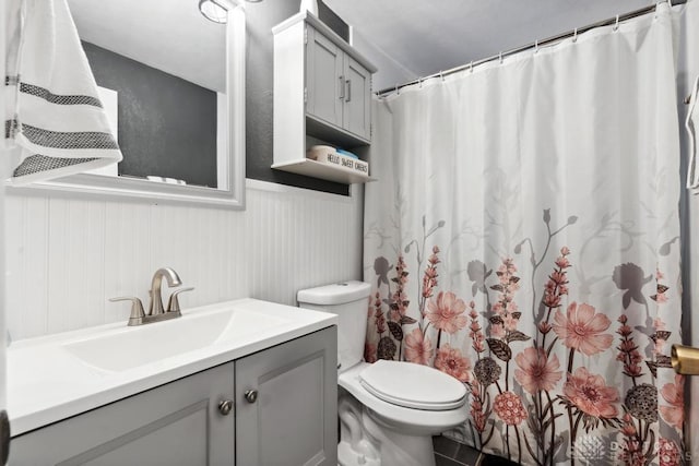 bathroom with vanity, toilet, and a shower with shower curtain