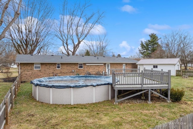 back of house with a pool side deck and a yard