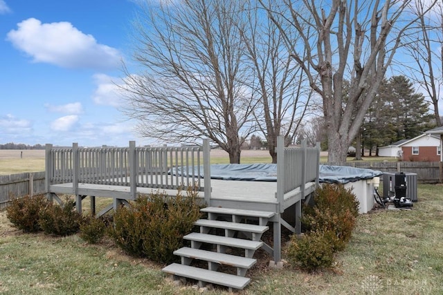 wooden terrace with a yard and a covered pool