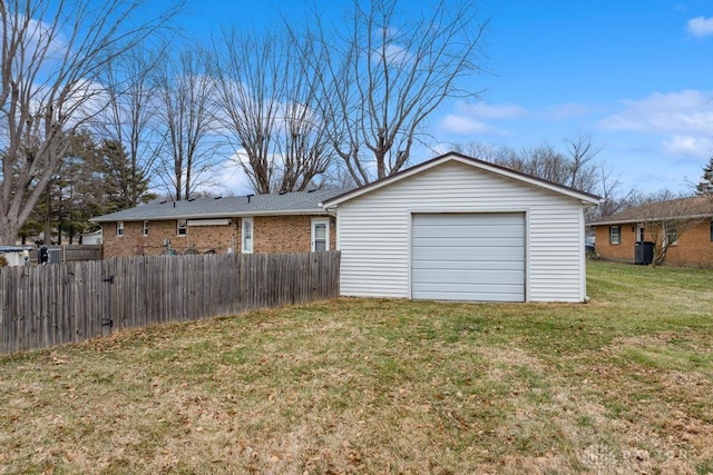 garage featuring central AC and a yard