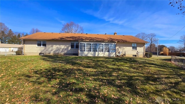 back of property featuring a lawn