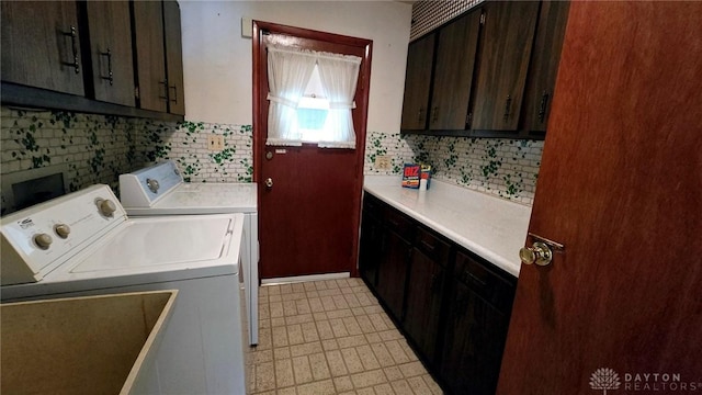 laundry room featuring cabinets and washing machine and clothes dryer