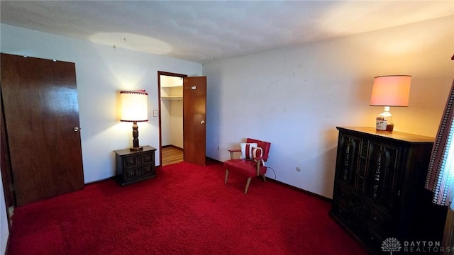 sitting room with dark colored carpet