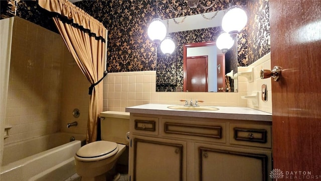 full bathroom with vanity, shower / bath combo with shower curtain, and toilet